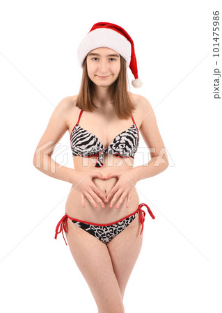 Young beautiful girl in a bathing suit isolated on a white background. Young beautiful girl in a bathing suit isolated on a white background. 101475986
