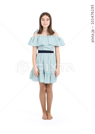 Young beautiful girl in a dress with polka dots on a white background. Young beautiful girl in a dress with polka dots on a white background. 101476195