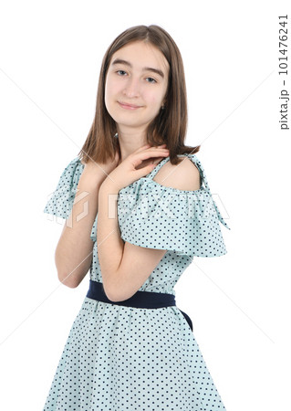 Young beautiful girl in a dress with polka dots on a white background. Young beautiful girl in a dress with polka dots on a white background. 101476241