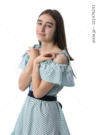 Young beautiful girl in a dress with polka dots on a white background. Young beautiful girl in a dress with polka dots on a white background. 101476242