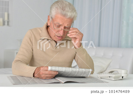 old nice man reading newspaper at home old nice man reading newspaper at home 101476489