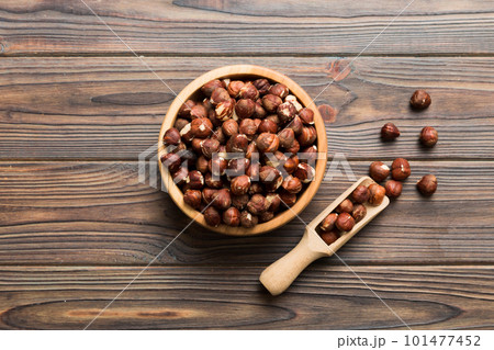 Wooden bowl full of hazelnuts on table background. Healthy eating concept. Super foods 101477452
