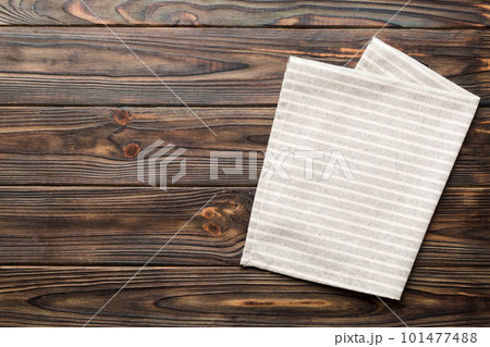 top view with gray kitchen napkin isolated on table background. Folded cloth for mockup with copy space, Flat lay. Minimal style top view with gray kitchen napkin isolated on table background. Folded cloth for mockup with copy space, Flat lay. Minimal style 101477488