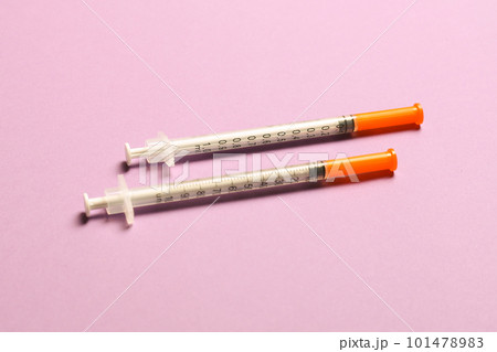 Top view of two insulin syringe at colorful background. High level of glucose concept 101478983