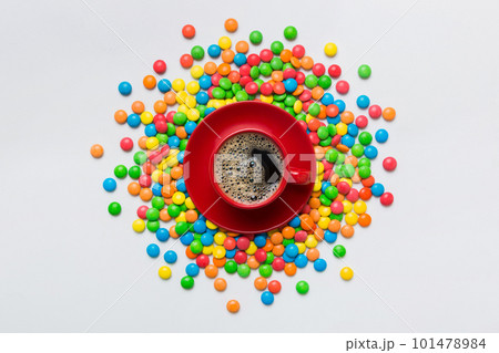 Coffee cup with chocolates and colored candy. Top view on table background with copy space 101478984