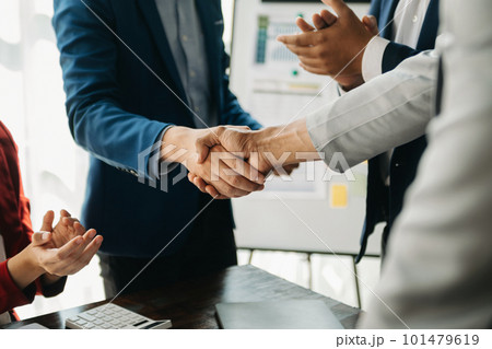 business people shaking hands during a meeting in office. business people shaking hands during a meeting in office. 101479619