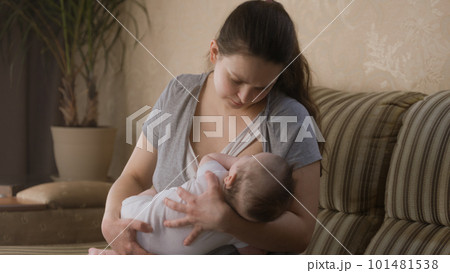 Caring mother breastfeeds little newborn child 101481538
