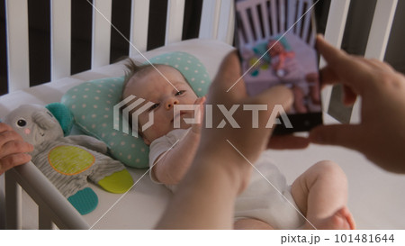 Couple takes a picture or video of little baby 101481644