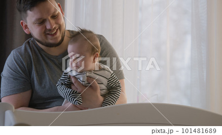 Loving father holds baby daughter or son in his arms 101481689
