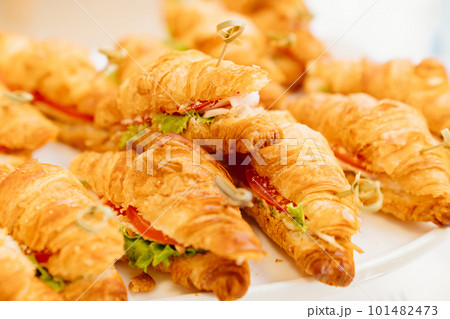 croissants stuffed with vegetables and meat. delicious snack. croissants stuffed with vegetables and meat. delicious snack. 101482473