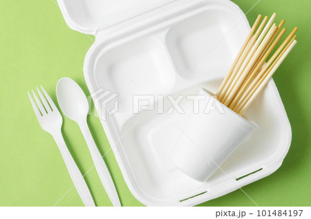 The Eco friendly biodegradable paper disposable for packaging food and paper glass on green background. The Eco friendly biodegradable paper disposable for packaging food and paper glass on green background. 101484197