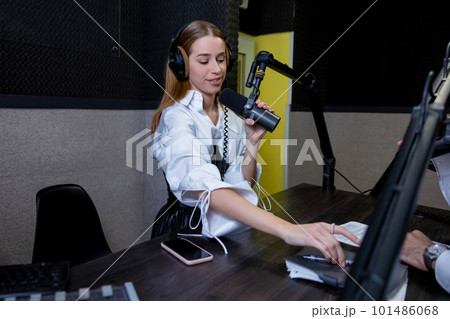 Long-haired young woman recording a soundtrack at the studio 101486068