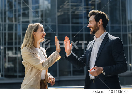 Business partners looking happy and contented 101486102