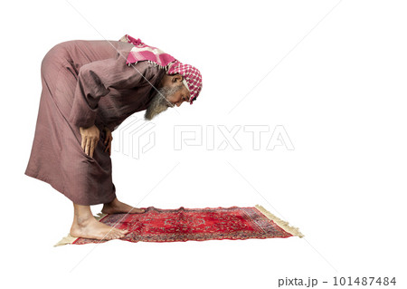Muslim man with a beard wearing keffiyeh with agal in praying position (salat) on the prayer rug Muslim man with a beard wearing keffiyeh with agal in praying position (salat) on the prayer rug 101487484