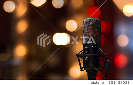 studio microphone in neon lights. sound recording equipment on bokeh background. Podcast,recording music concept microphone 101488081