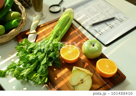 Fruit and vegetable on chopping board with Nutrition Facts on table. 101488410