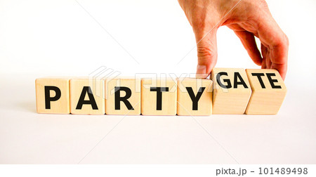 Party and partygate symbol. Concept words Party and Partygate on wooden cubes. Businessman hand. Beautiful white table white background. Business party and partygate concept. Copy space. Party and partygate symbol. Concept words Party and Partygate on wooden cubes. Businessman hand. Beautiful white table white background. Business party and partygate concept. Copy space. 101489498
