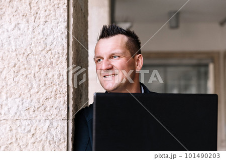 A confident business person with a laptop in the city. Business vision, communications, online shopping A confident business person with a laptop in the city. Business vision, communications, online shopping 101490203