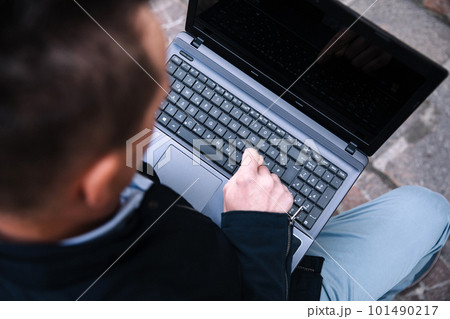 A confident business person with a laptop in the city. Business vision, communications, online shopping A confident business person with a laptop in the city. Business vision, communications, online shopping 101490217