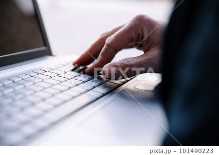 Men's hand typing on a laptop keyboard. Selective focus Men's hand typing on a laptop keyboard. Selective focus 101490223