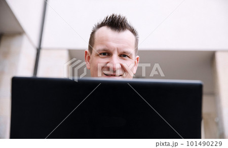 A confident business person with a laptop in the city. Business vision, communications, online shopping 101490229