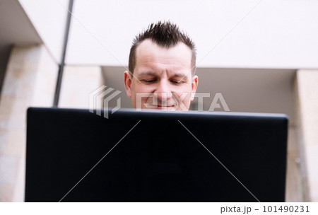 A confident business person with a laptop in the city. Business vision, communications, online shopping 101490231