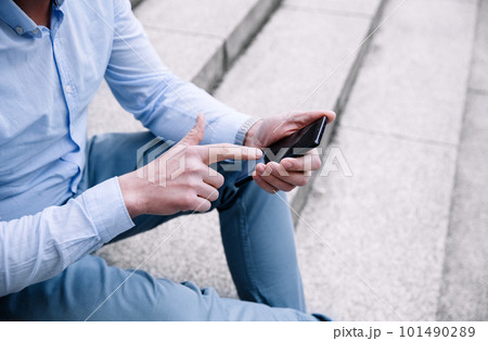 A confident business person with a smartphone in the city. Business vision, communications, online shopping A confident business person with a smartphone in the city. Business vision, communications, online shopping 101490289
