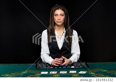 The beautiful girl, dealer, behind a table for poker 101491332