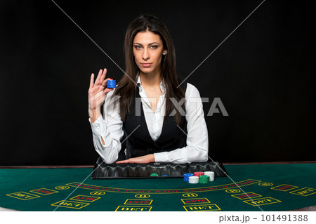 The beautiful girl, dealer, behind a table for poker 101491388