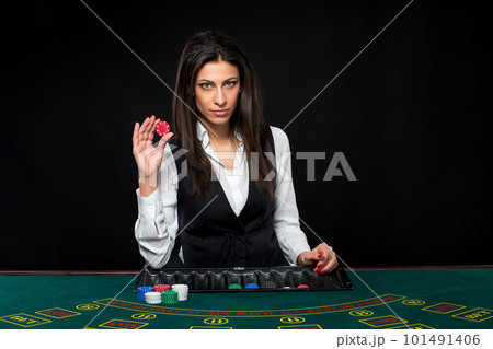 The beautiful girl, dealer, behind a table for poker 101491406