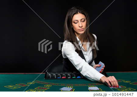 The beautiful girl, dealer, behind a table for poker 101491447