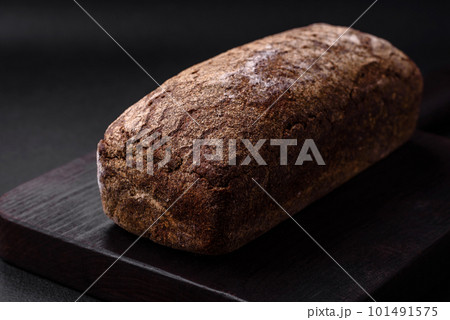 Loaf of fresh crispy brown bread with grains and seeds 101491575