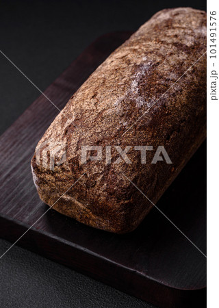 Loaf of fresh crispy brown bread with grains and seeds Loaf of fresh crispy brown bread with grains and seeds 101491576