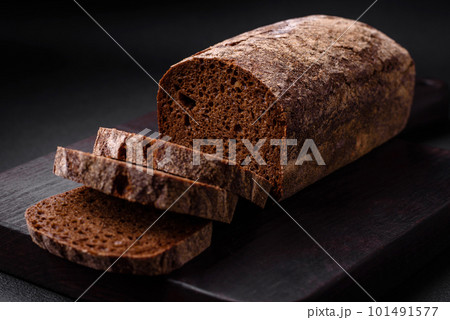 Loaf of fresh crispy brown bread with grains and seeds Loaf of fresh crispy brown bread with grains and seeds 101491577
