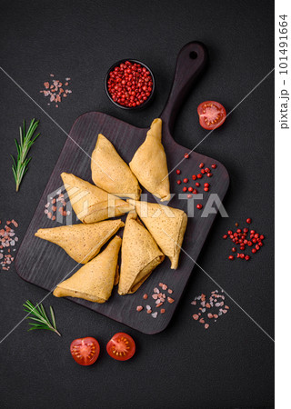 Delicious pancakes triangular shape with meat, salt and spices Delicious pancakes triangular shape with meat, salt and spices 101491664