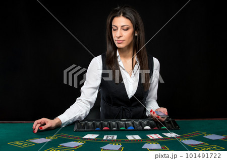 The beautiful girl, dealer, behind a table for poker 101491722
