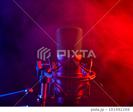 Professional microphone in pink smoke on a black background. Professional microphone in pink smoke on a black background. 101492208