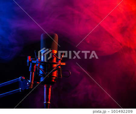 Professional microphone in pink smoke on a black background. Professional microphone in pink smoke on a black background. 101492209