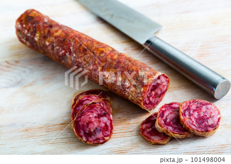 Appetizing salchichon sausage on wooden table 101498004
