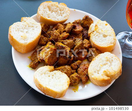 Pinchos morunos, moorish skewers with bread Pinchos morunos, moorish skewers with bread 101498530