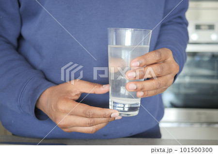 dirty water pouring from a faucet tap in a glass, dirty water pouring from a faucet tap in a glass, 101500300