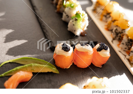 Close up of tasty japanese uramaki sushi with salmon Close up of tasty japanese uramaki sushi with salmon 101502337
