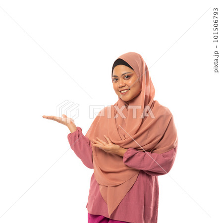 Asian Muslim woman wearing hijab with hands presenting something Asian Muslim woman wearing hijab with hands presenting something 101506793