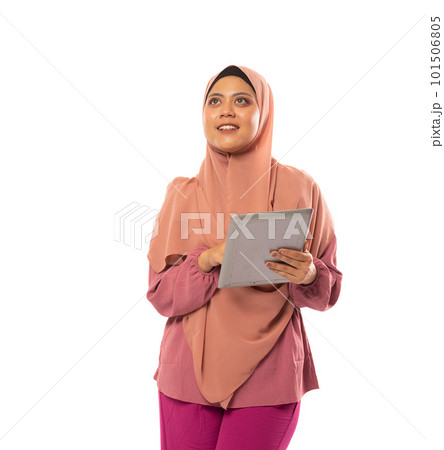 muslimah in hijab looking up using tablet in isolated background muslimah in hijab looking up using tablet in isolated background 101506805