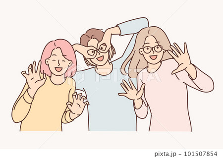 Happy girls of friend have fun making funny faces and putting fingers to faces instead of glasses 101507854