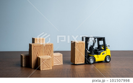 Forklift transports wooden boxes in a warehouse. Logistic infrastructure and warehousing services. Transportation industry. Trade Shipping logistics. Sending orders. Supply by products and goods. 101507998