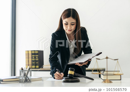 Business lawyer woman holding business contract to reading and w Business lawyer woman holding business contract to reading and w 101508570