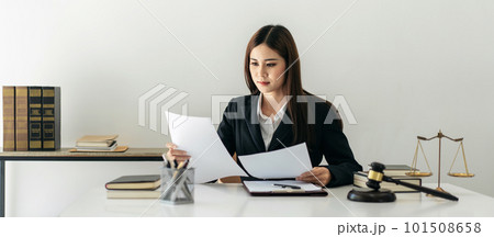 Business lawyer woman holding business contract to reading while Business lawyer woman holding business contract to reading while 101508658