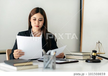 Business lawyer woman holding business contract to reading while 101508659