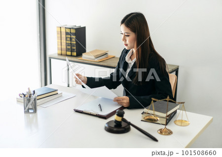 Business lawyer woman holding business contract to reading while 101508660